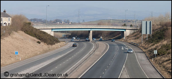 Typical motorway beam bridge constructed from steel and concrete. This one carries the B6231 over the M65 in Lancashire.